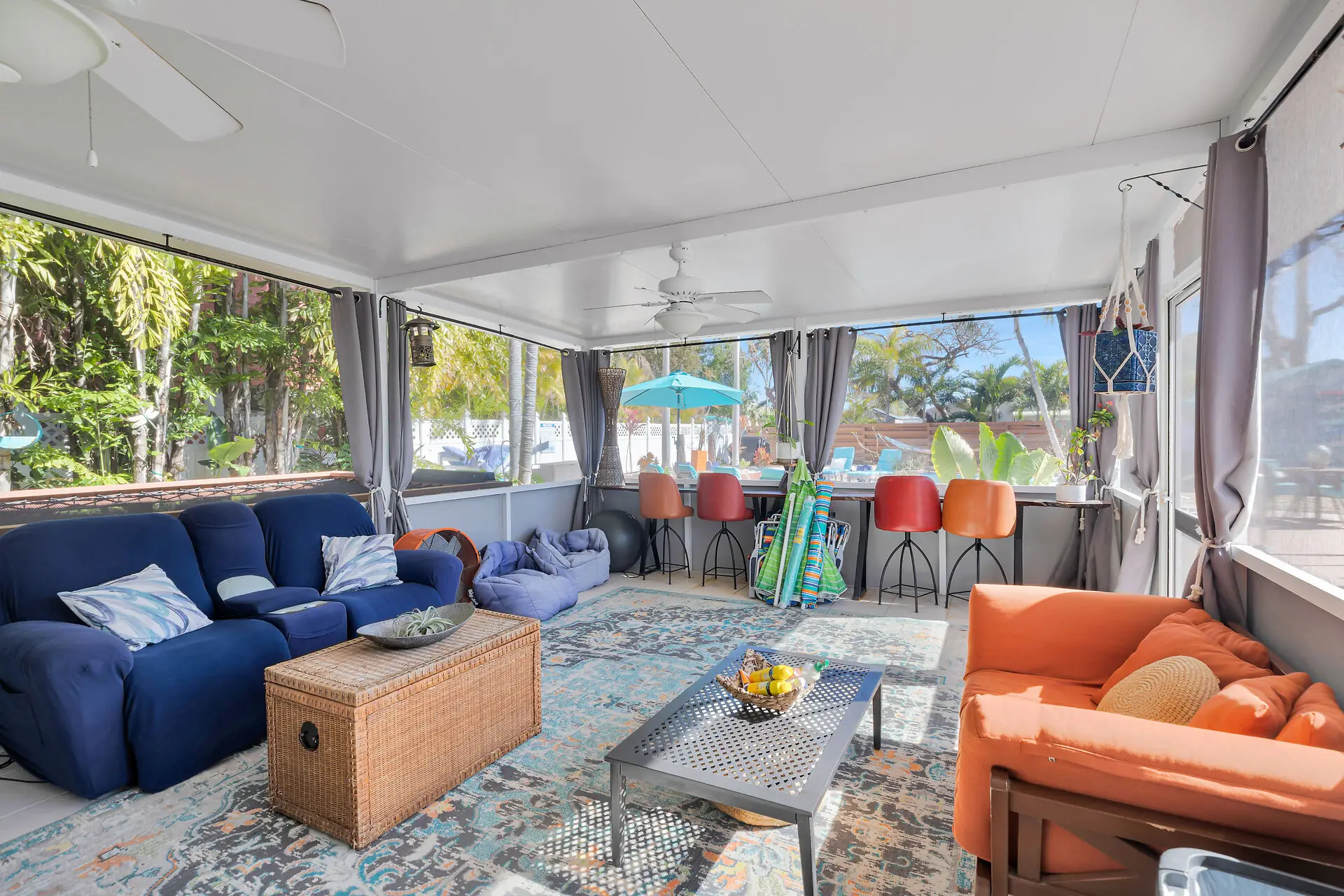 Screened Florida room with lounge seating and pool views