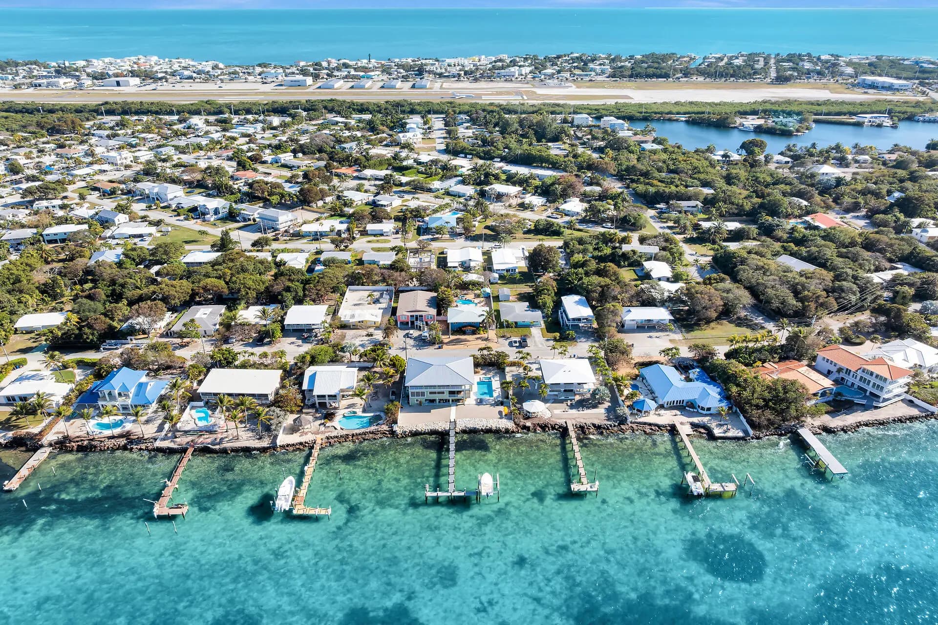 Aerial view over the turquoise Gulf of Mexico and neighborhood docks