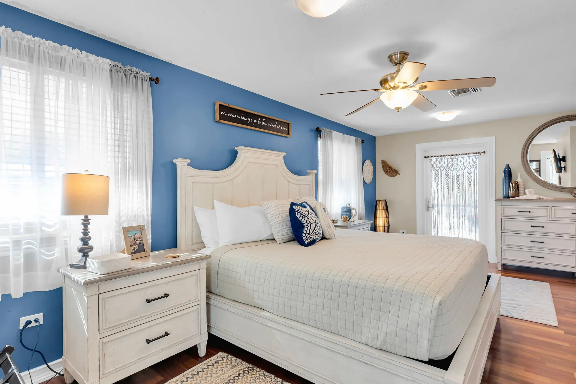 Master suite with a king bed and ocean-blue accent wall